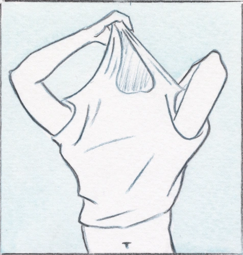 A man begins pulling his shirt over his head